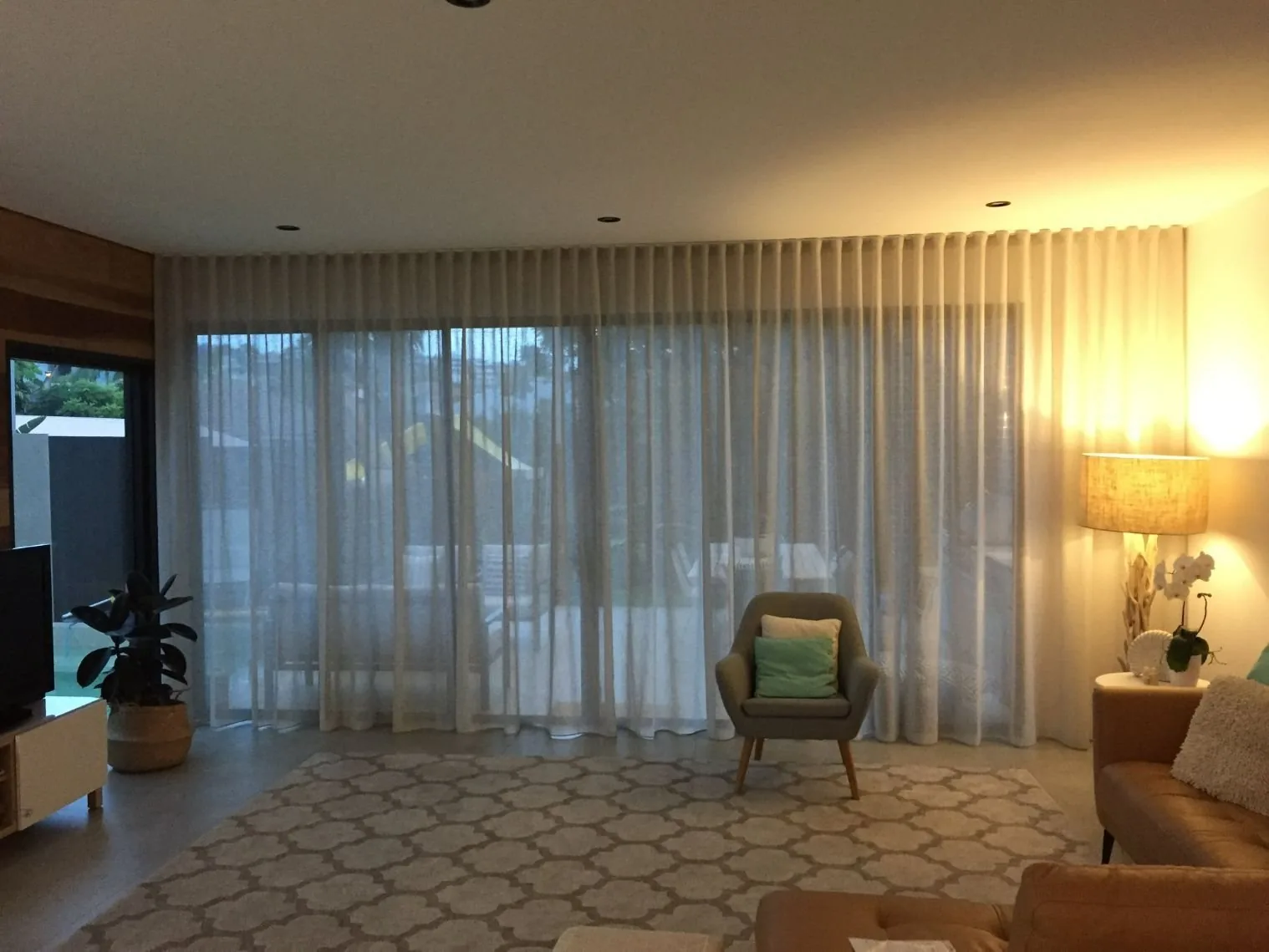 Full-length curtains framing a warmly lit Brisbane living room