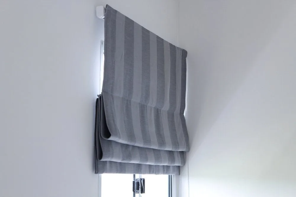 Roman blinds fitted across a pair of interior windows