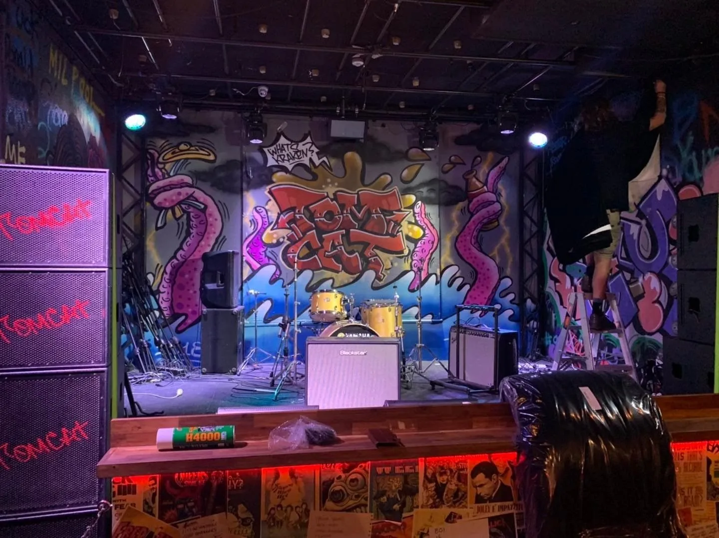 Stage curtains hung across a venue stage