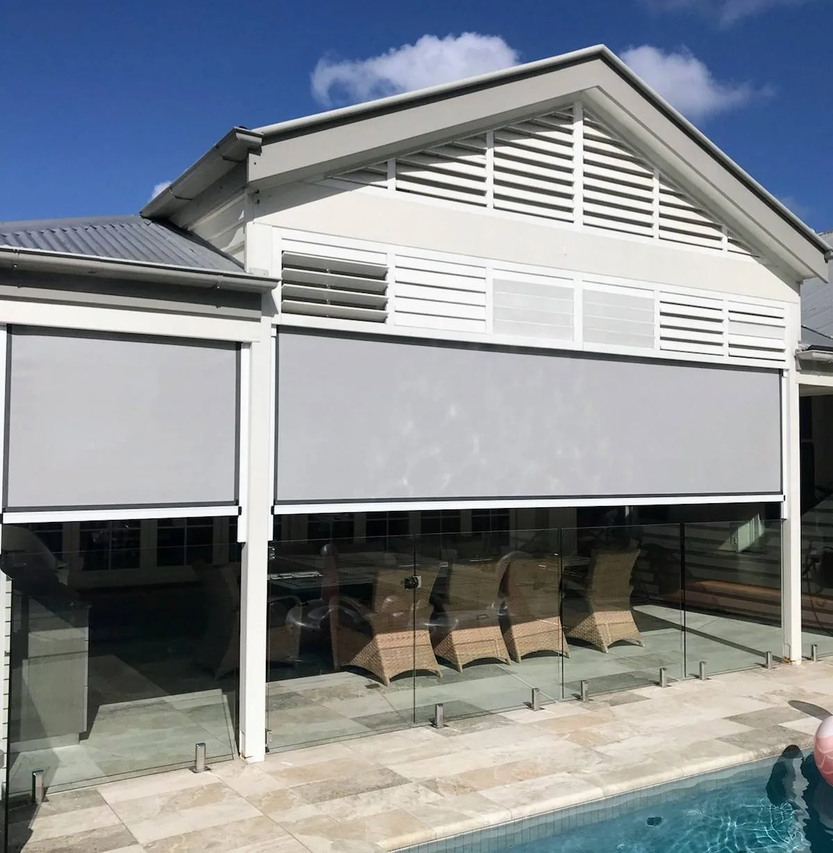Outdoor blinds fitted along a covered poolside verandah
