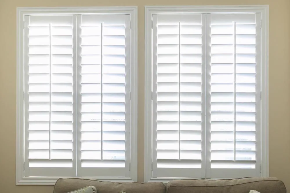 White plantation shutters in a yellow room — plantation shutters in Brisbane